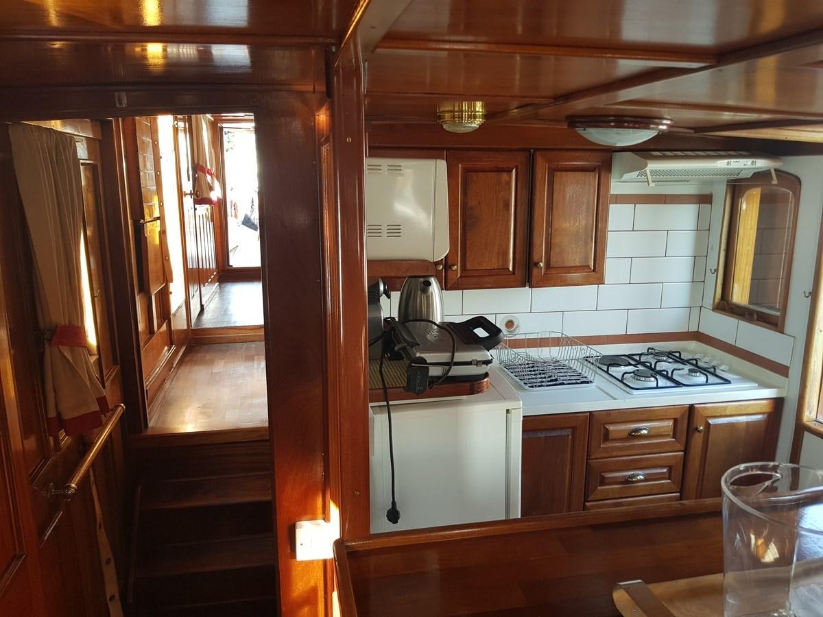 a kitchen with wooden cabinets aboard LADY EMMA Yacht for Sale