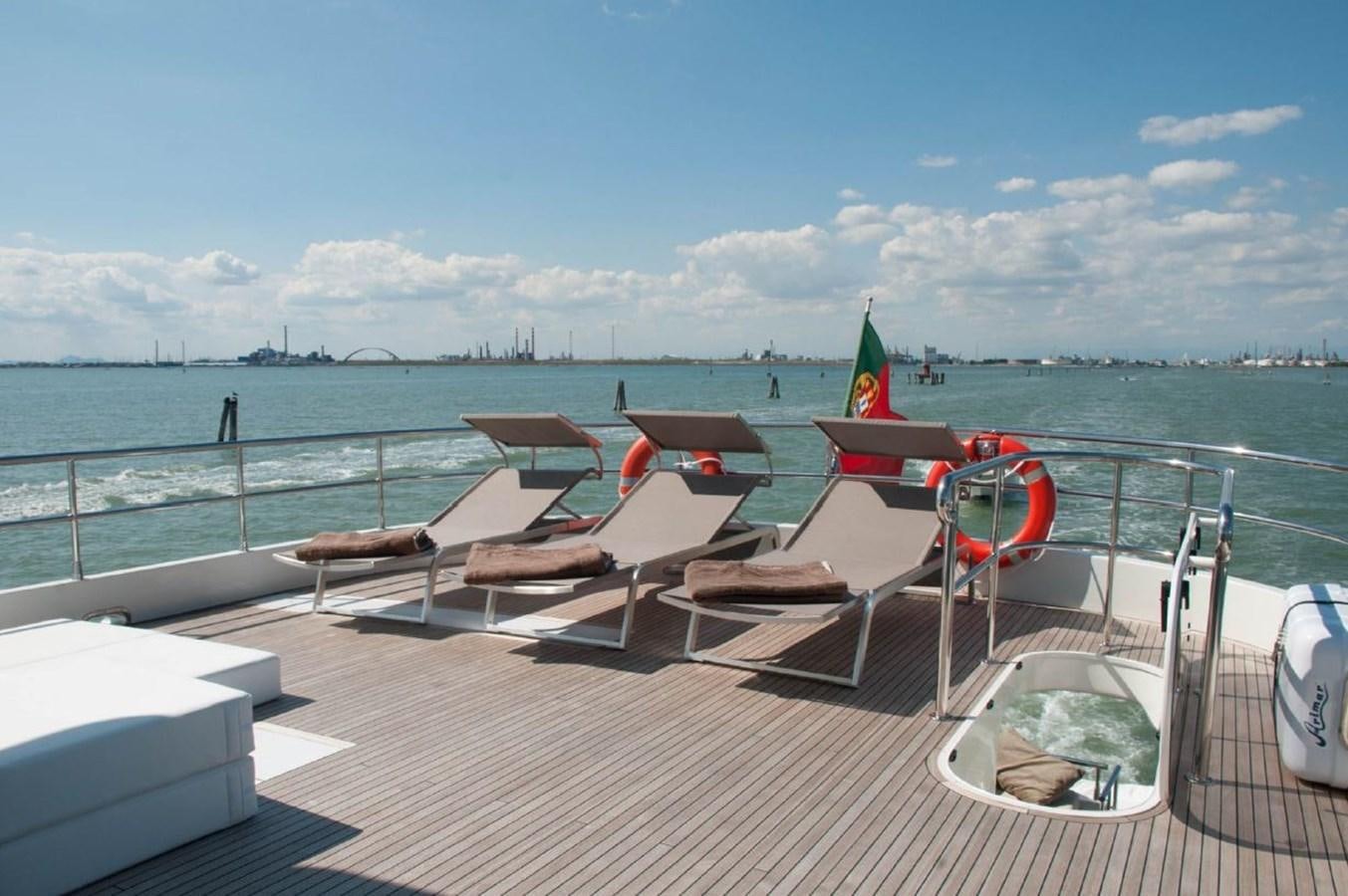 a deck with chairs and a boat on it aboard MY WAY Yacht for Sale