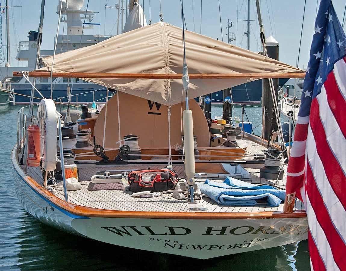 a boat with a flag on the front aboard WILD HORSES Yacht for Sale