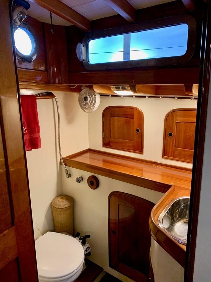 a small bathroom with a small window aboard WILD HORSES Yacht for Sale