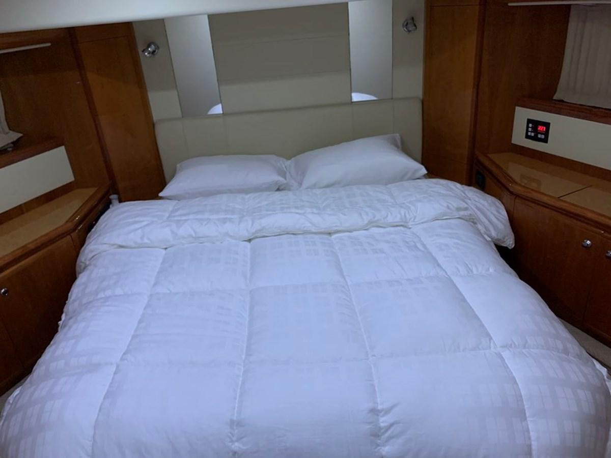 a bed with white sheets aboard MARIELA Yacht for Sale