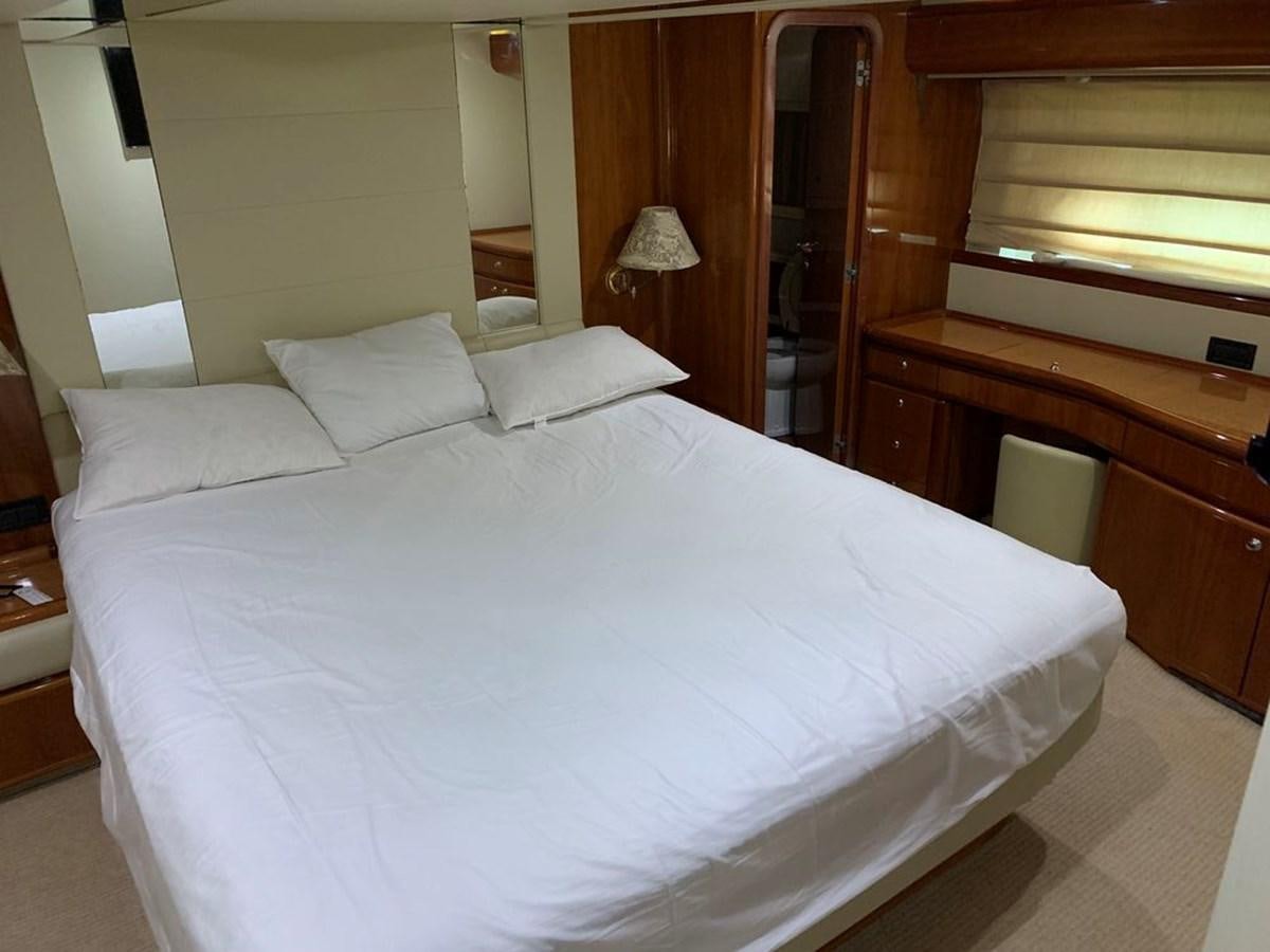 a bed with white sheets aboard MARIELA Yacht for Sale