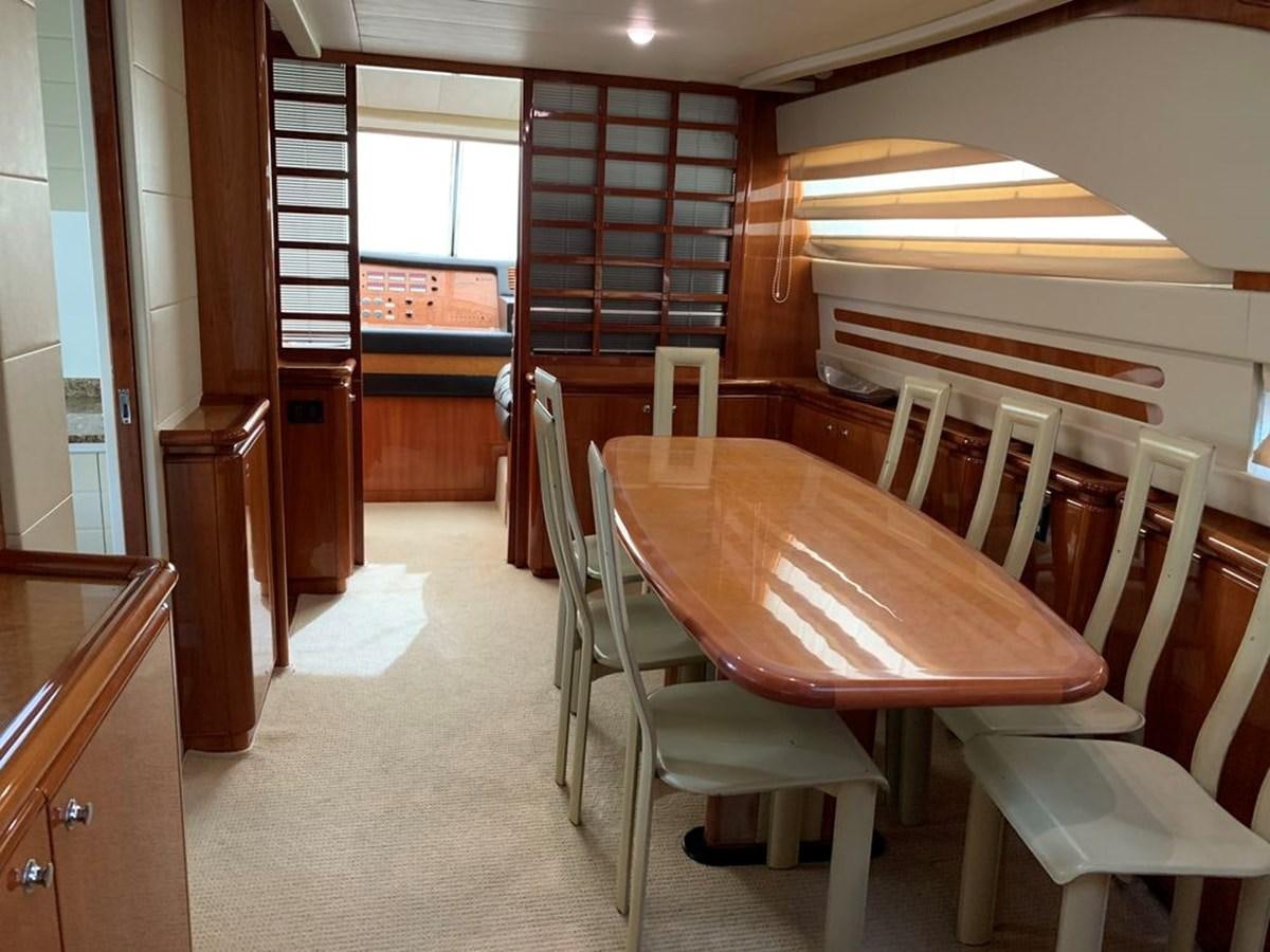 a dining table and chairs in a room aboard MARIELA Yacht for Sale