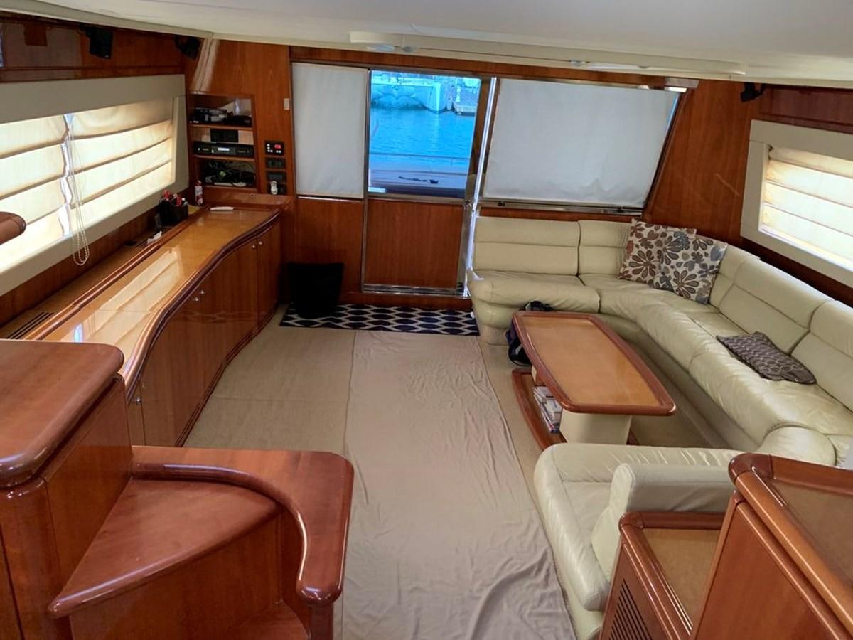 a living room with a couch and a tv aboard MARIELA Yacht for Sale