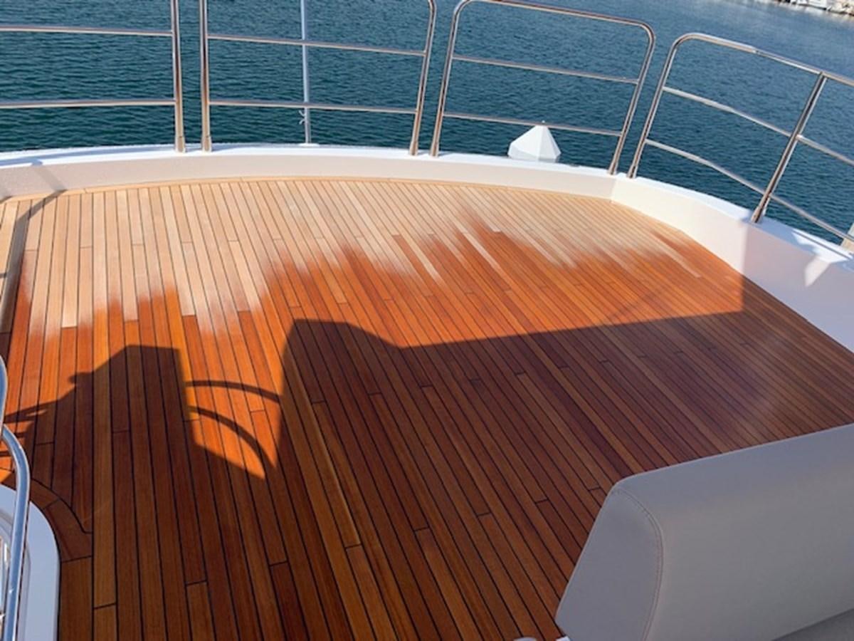 a wooden table with a white chair aboard SEA SCAPE Yacht for Sale