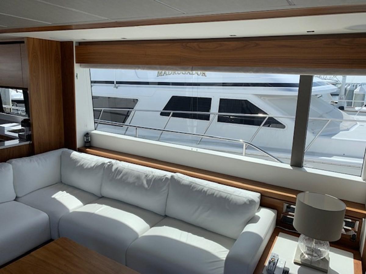 a living room with a large window aboard SEA SCAPE Yacht for Sale