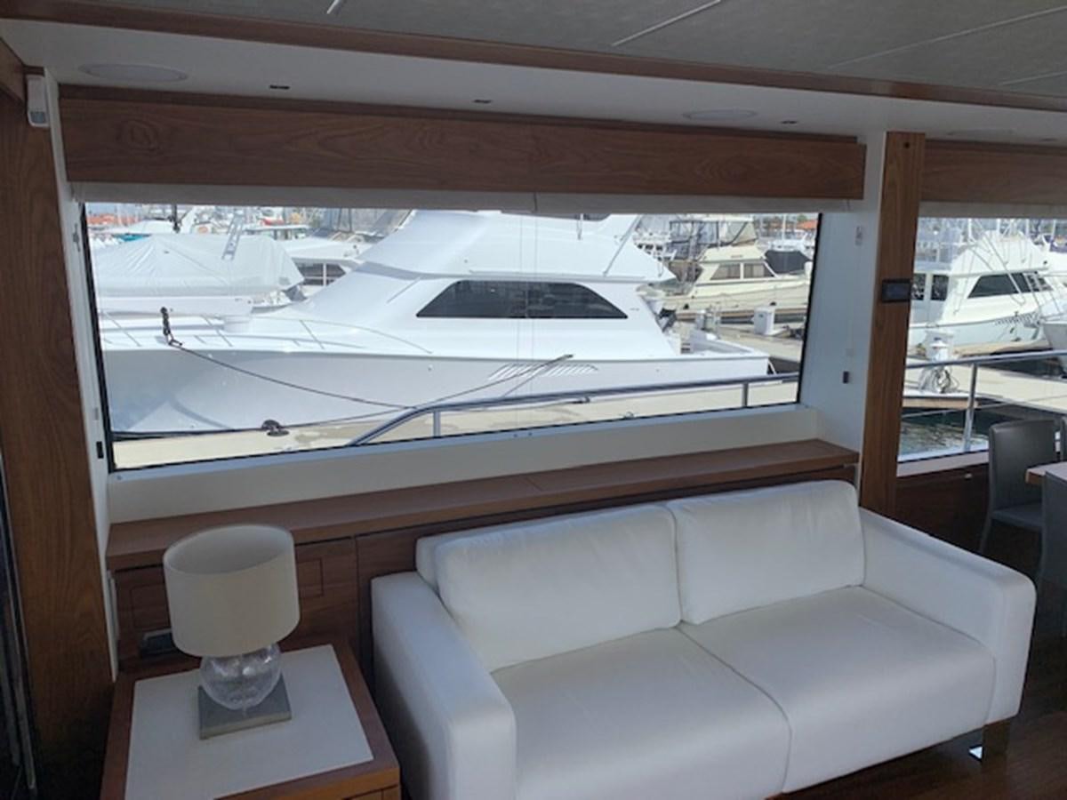 a living room with a large window aboard SEA SCAPE Yacht for Sale