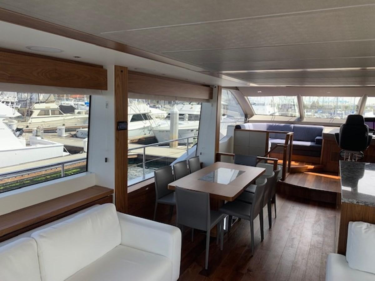 a room with a table and chairs aboard SEA SCAPE Yacht for Sale