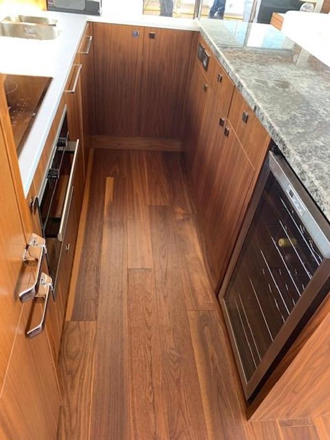 a kitchen with wooden cabinets aboard SEA SCAPE Yacht for Sale