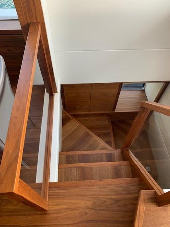 a wooden staircase with a railing aboard SEA SCAPE Yacht for Sale
