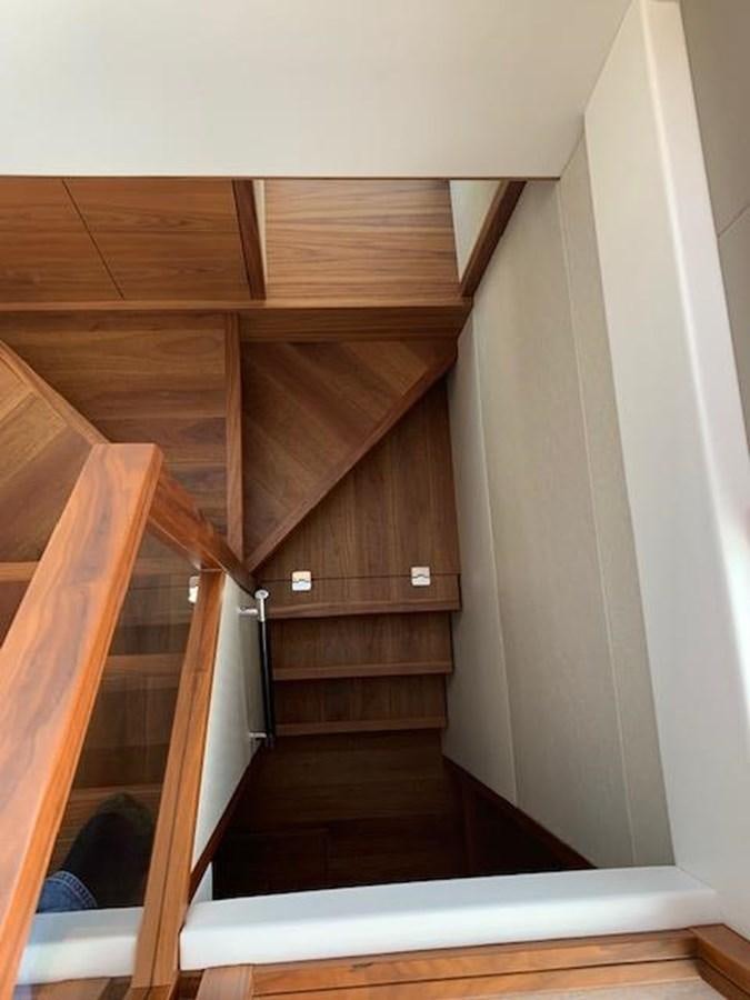 a wooden staircase with a wood railing aboard SEA SCAPE Yacht for Sale