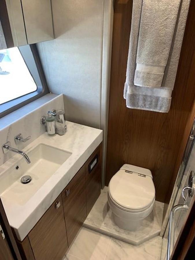 a bathroom with a toilet and sink aboard SEA SCAPE Yacht for Sale