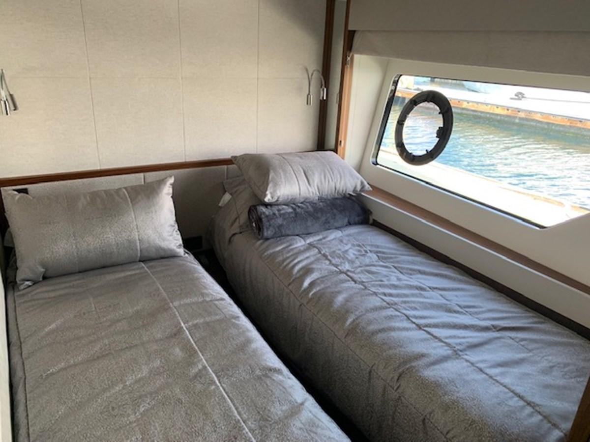 a bed with a pillow and a window aboard SEA SCAPE Yacht for Sale