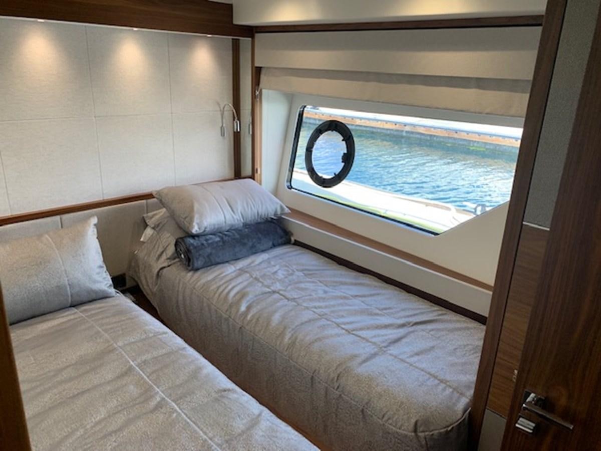 a bed with a window aboard SEA SCAPE Yacht for Sale