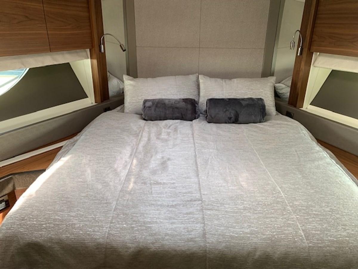 a bed with white sheets aboard SEA SCAPE Yacht for Sale