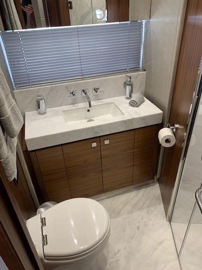 a bathroom with a toilet and sink aboard SEA SCAPE Yacht for Sale