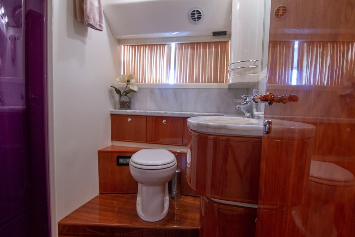 a bathroom with a toilet sink and cabinets aboard SEA PAL Yacht for Sale