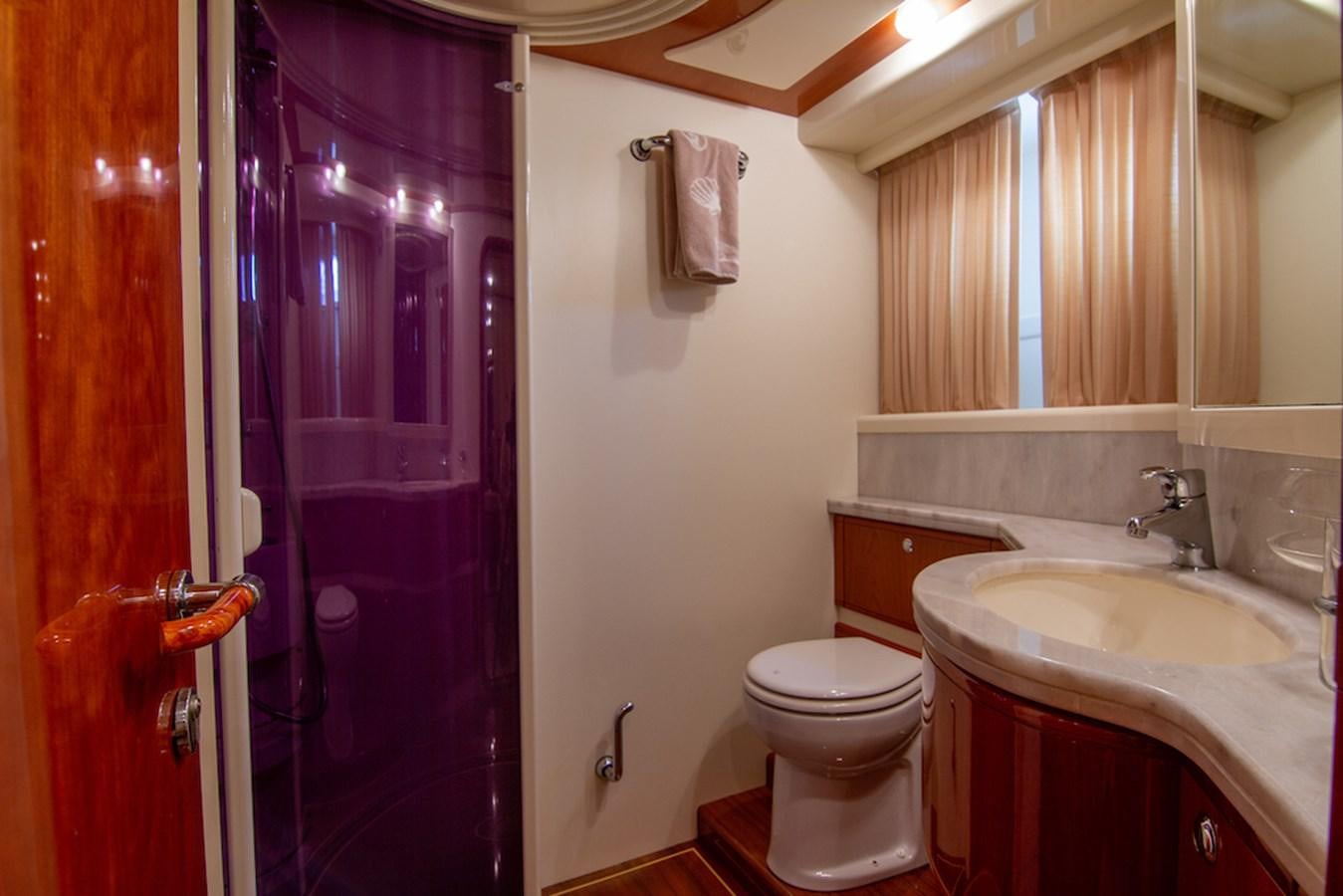 a bathroom with a pink shower curtain aboard SEA PAL Yacht for Sale