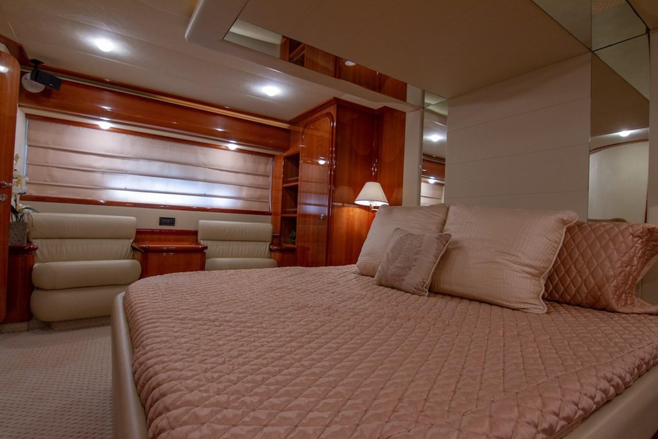 a bed with a white comforter aboard SEA PAL Yacht for Sale