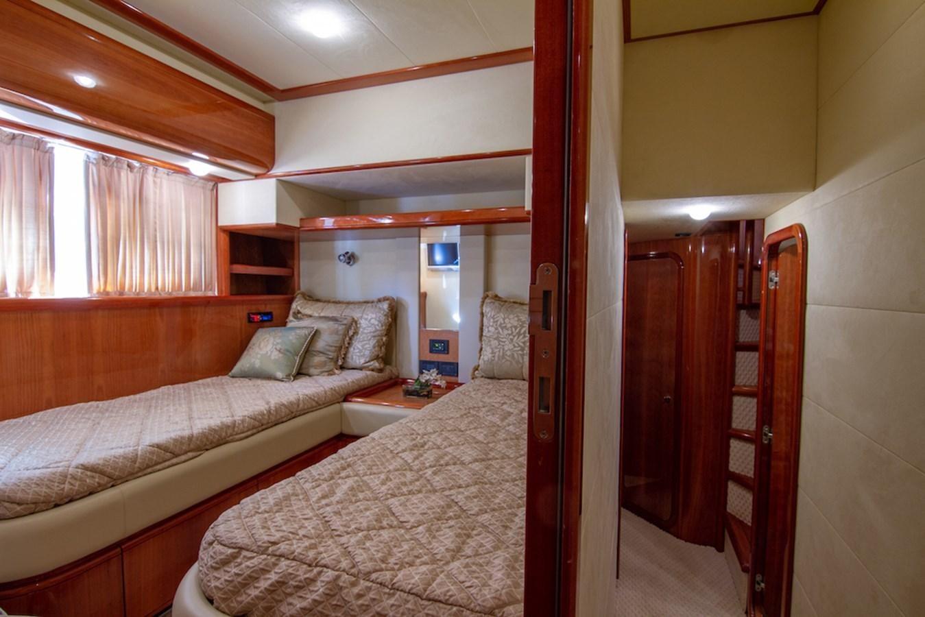 a bedroom with a bed and a wood door aboard SEA PAL Yacht for Sale