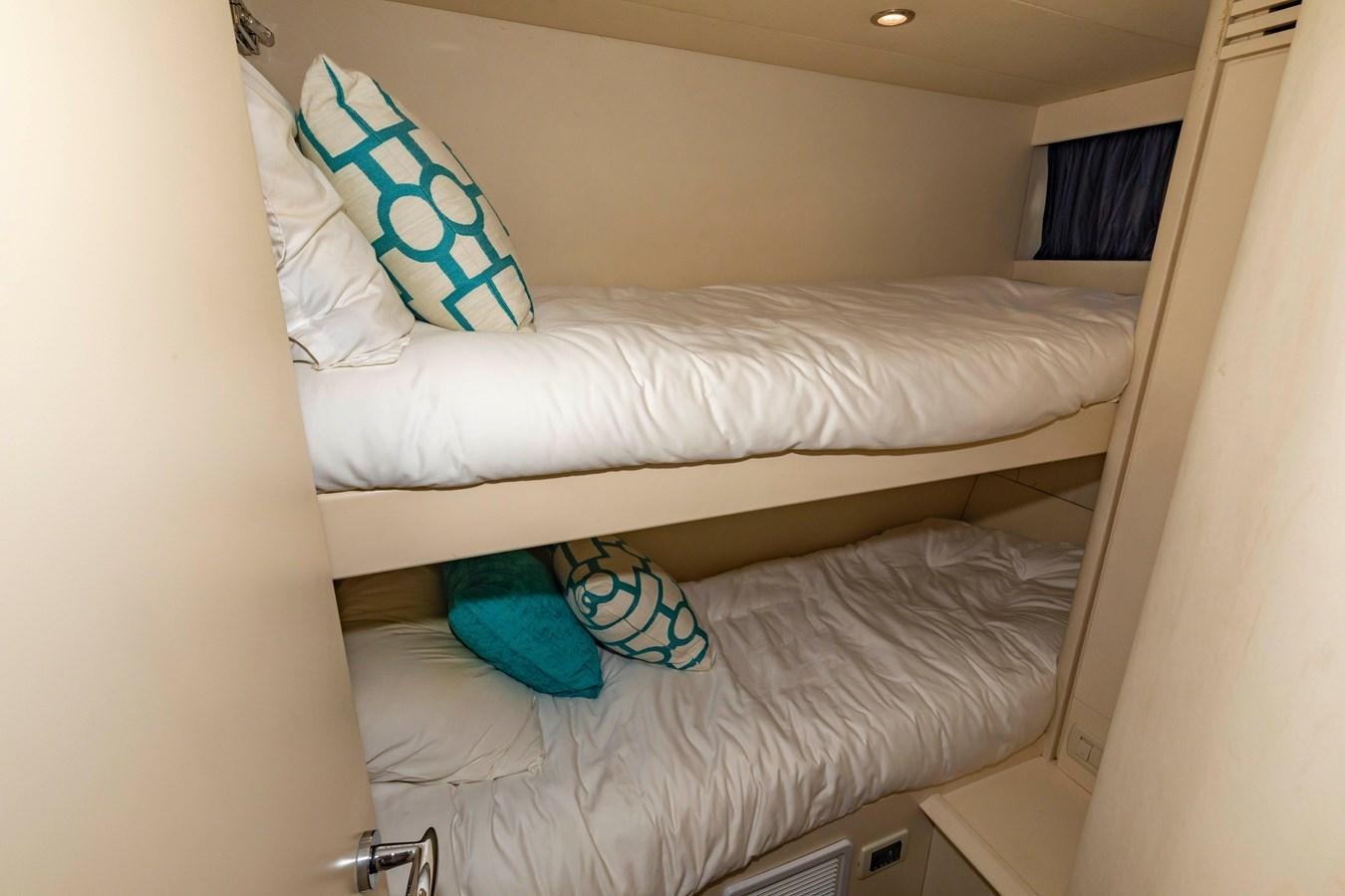 a bed with a blue pillow aboard FREE SPIRIT Yacht for Sale