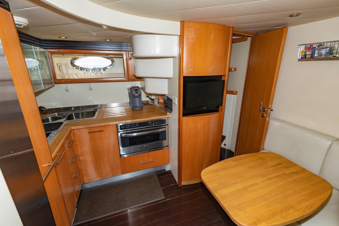 a kitchen with wooden cabinets aboard FREE SPIRIT Yacht for Sale