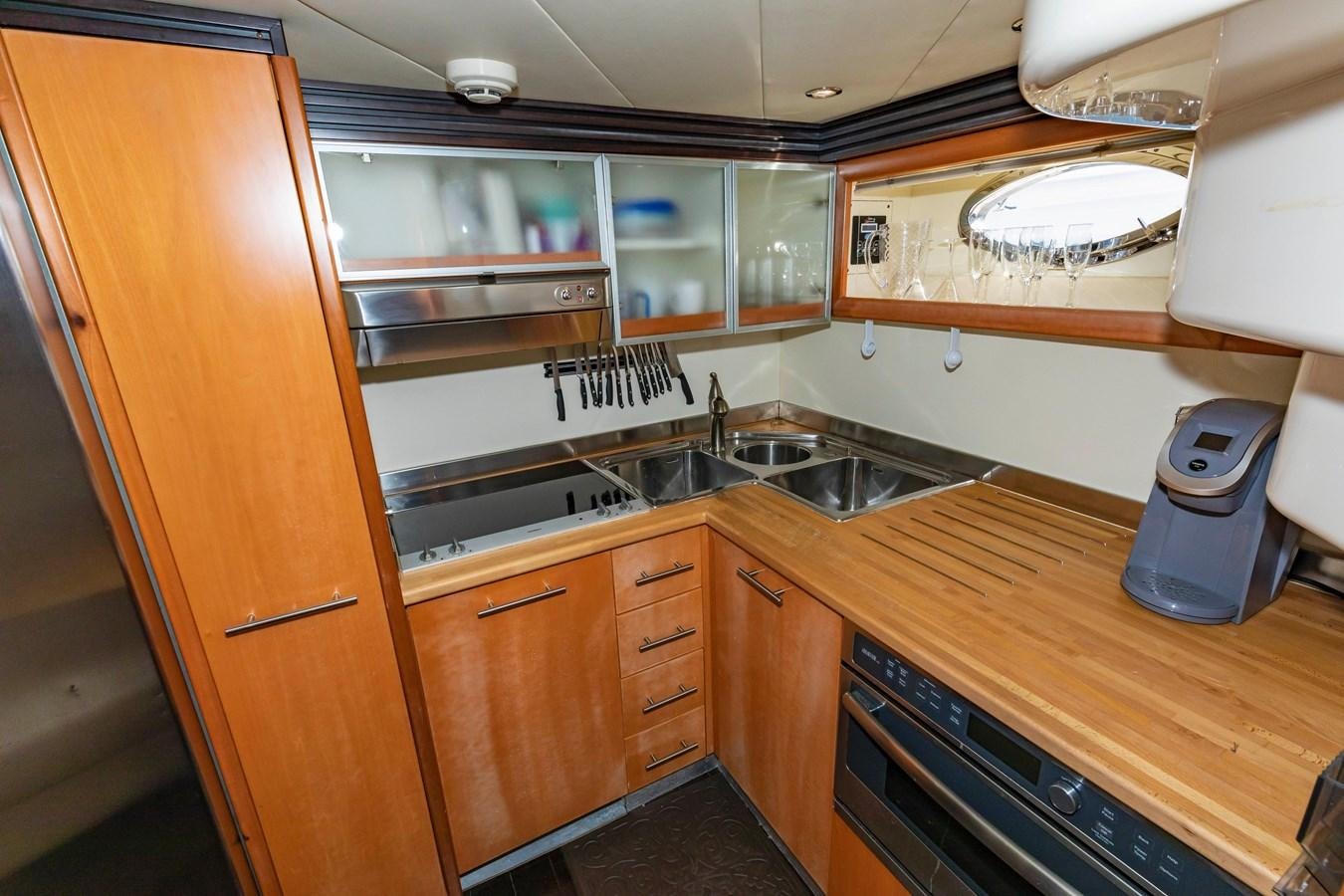 a kitchen with wooden cabinets aboard FREE SPIRIT Yacht for Sale