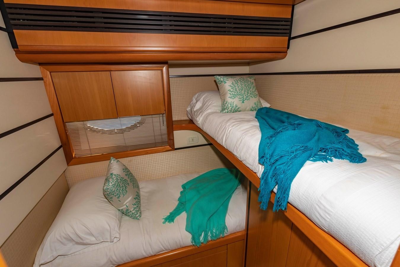 a bed with a blue blanket aboard FREE SPIRIT Yacht for Sale
