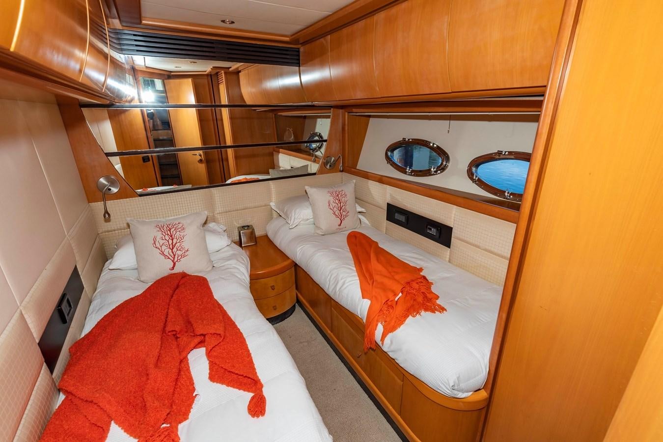 a room with a bed and a mirror aboard FREE SPIRIT Yacht for Sale