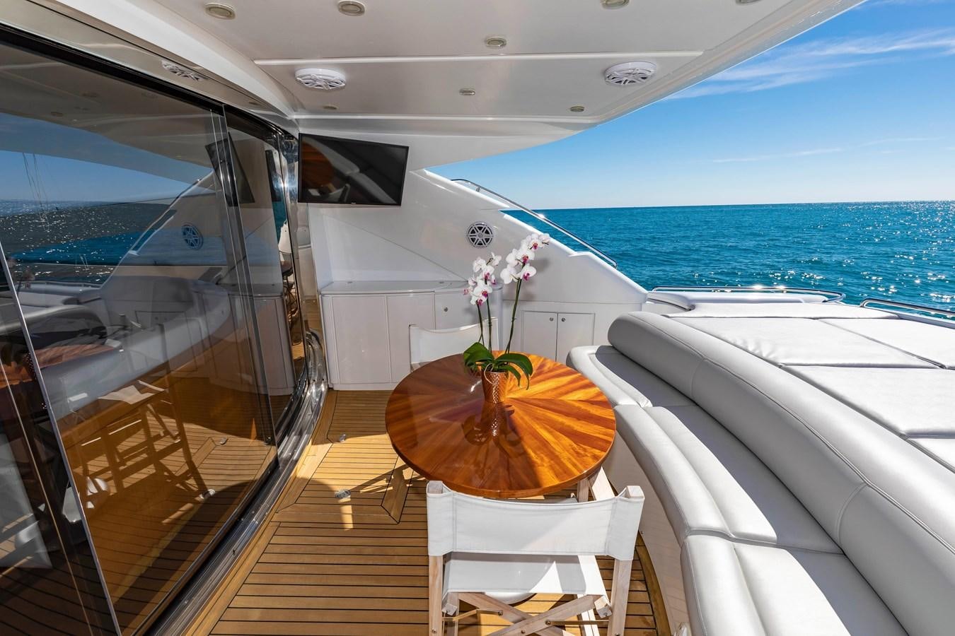 a boat with a table and chairs on the deck aboard FREE SPIRIT Yacht for Sale