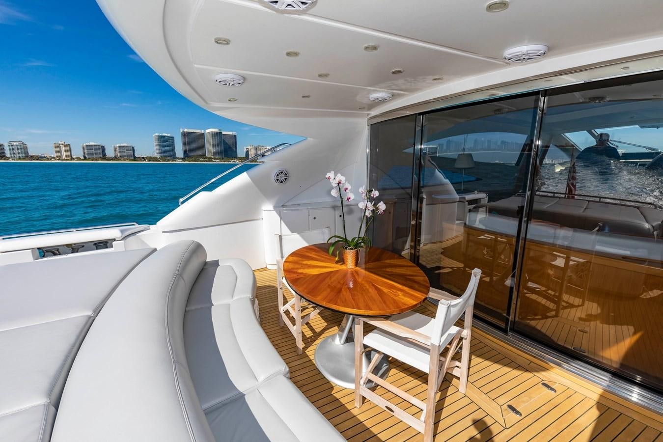 a boat with a table and chairs on a deck aboard FREE SPIRIT Yacht for Sale