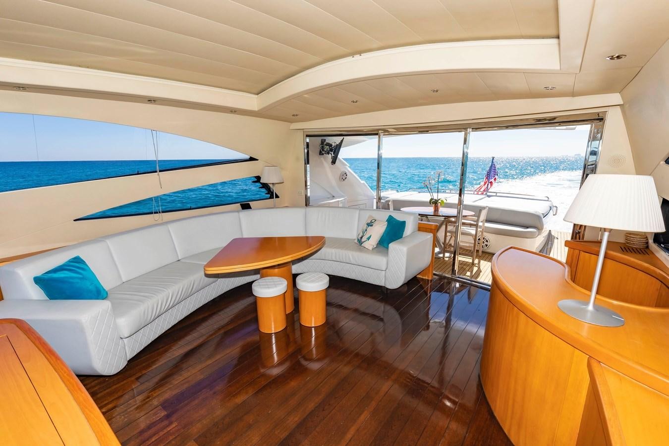 a room with a bed and a table and chairs aboard FREE SPIRIT Yacht for Sale