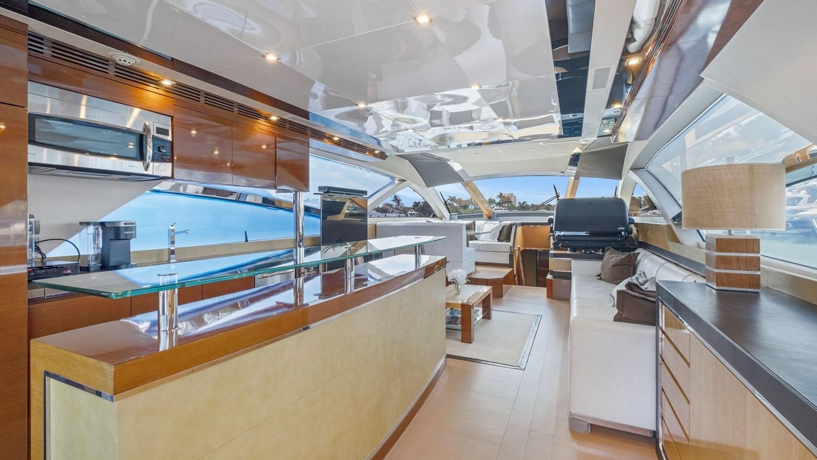 a room with a large display of electronics and a large shelf with a tv and a large wood aboard Gramercy 28 Yacht for Sale