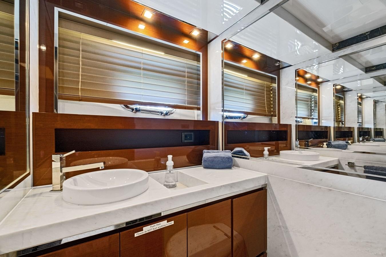 a bathroom with a large mirror aboard Gramercy 28 Yacht for Sale