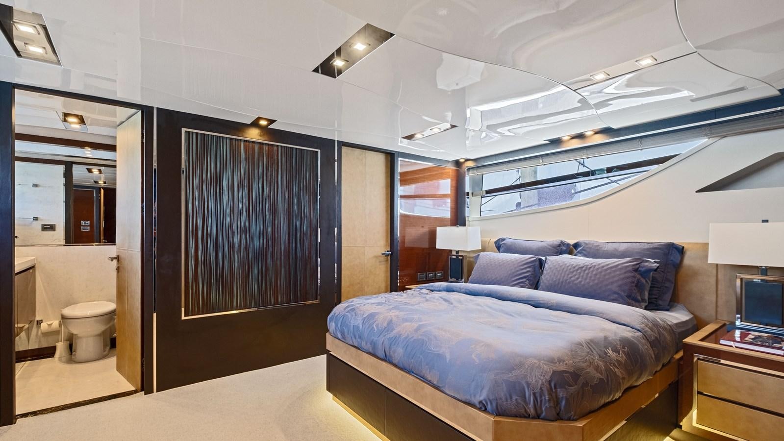 a bedroom with a bed and a desk aboard Gramercy 28 Yacht for Sale