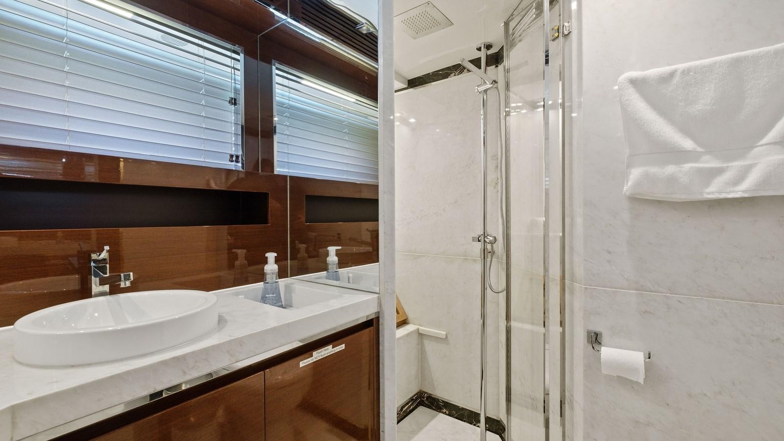 a bathroom with a sink and shower aboard Gramercy 28 Yacht for Sale