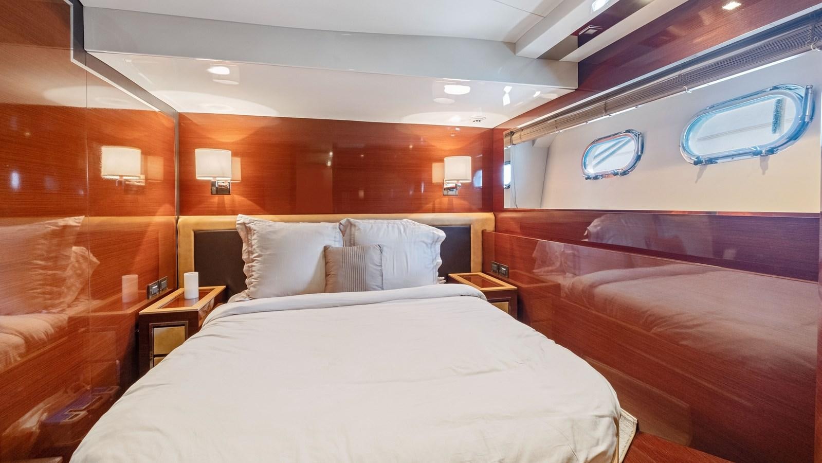a room with a bed and a window aboard Gramercy 28 Yacht for Sale