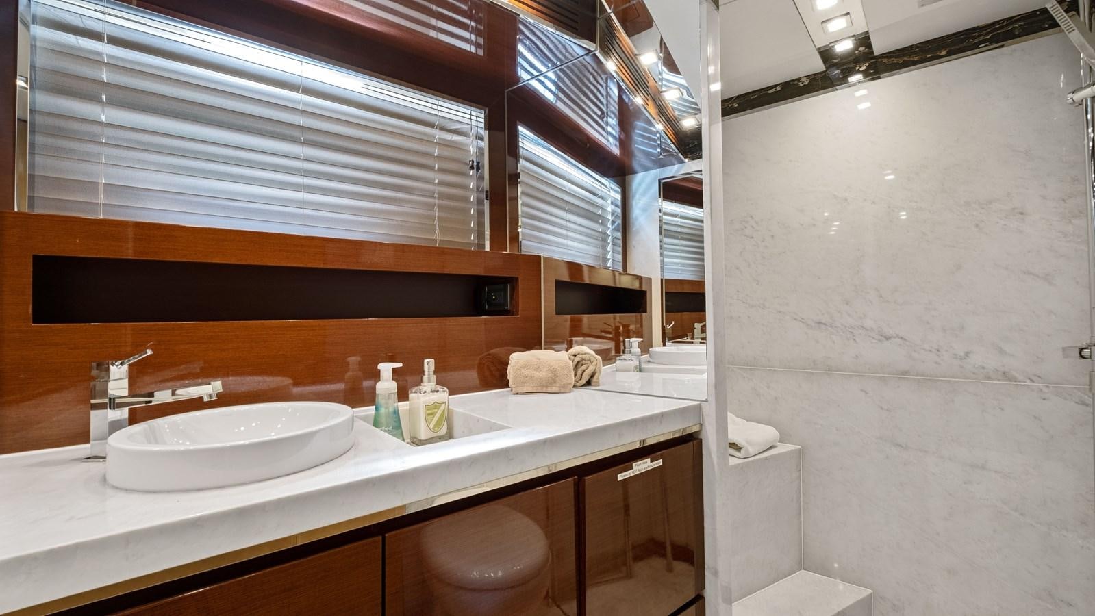 a bathroom with a sink and a window aboard Gramercy 28 Yacht for Sale
