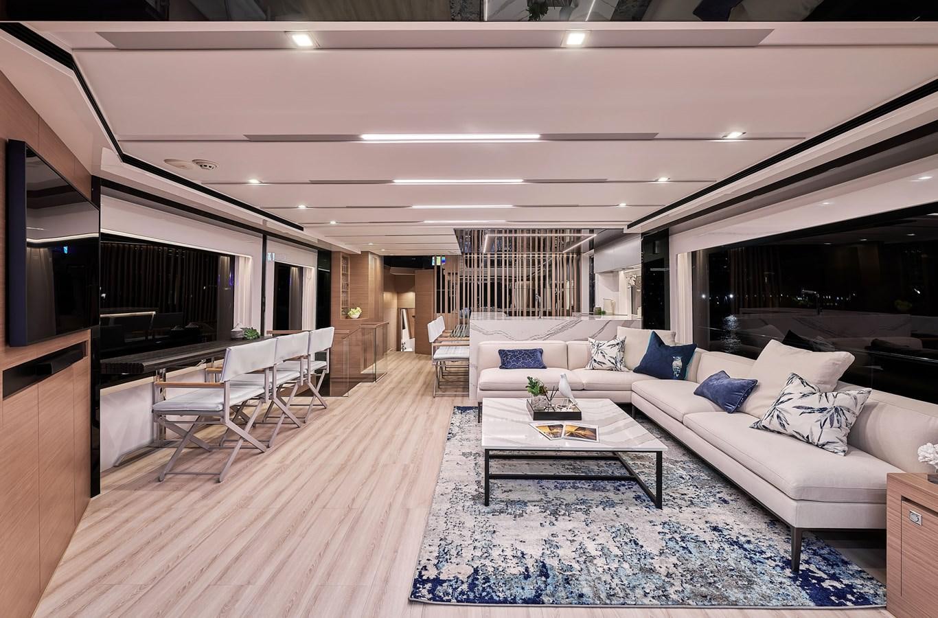 a living room with a large white couch and a large tv aboard FD75  709 Yacht for Sale