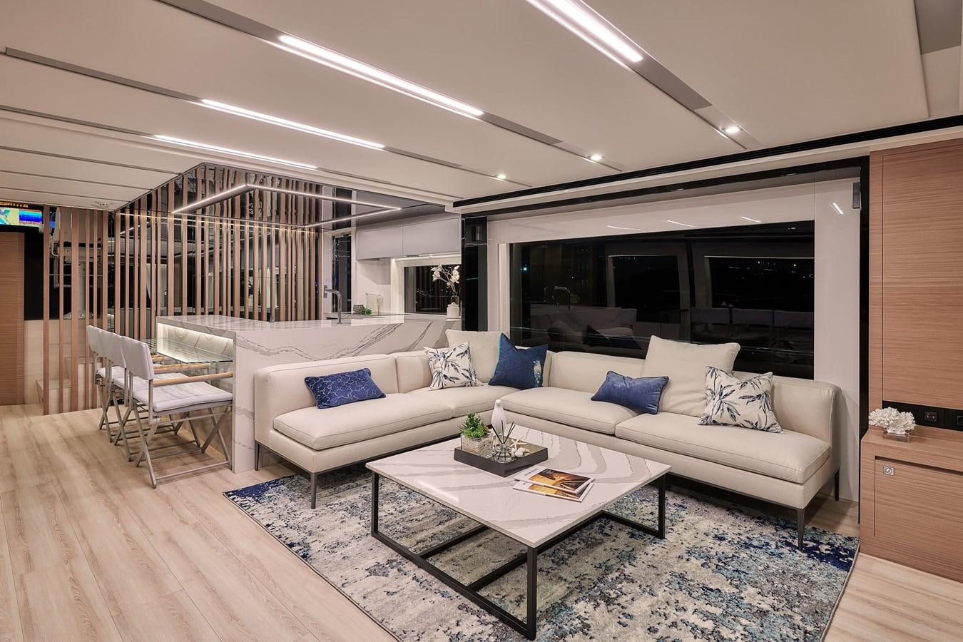 a living room with a large screen aboard FD75  709 Yacht for Sale