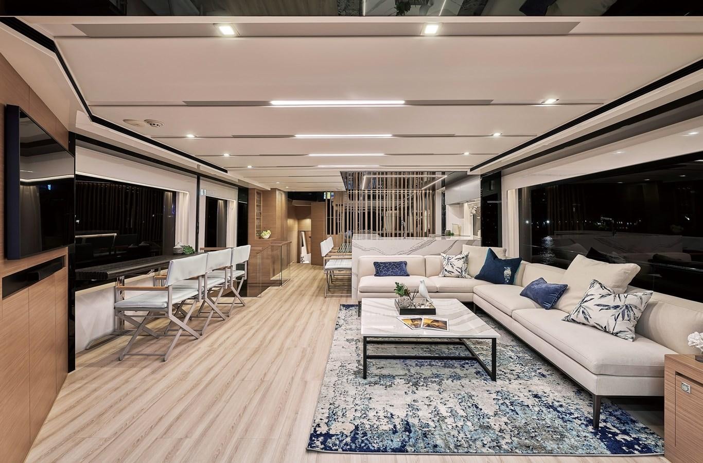 a living room with a large white couch and a large window aboard FD75  709 Yacht for Sale