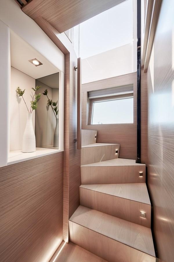 a staircase with a vase of flowers aboard FD75  709 Yacht for Sale