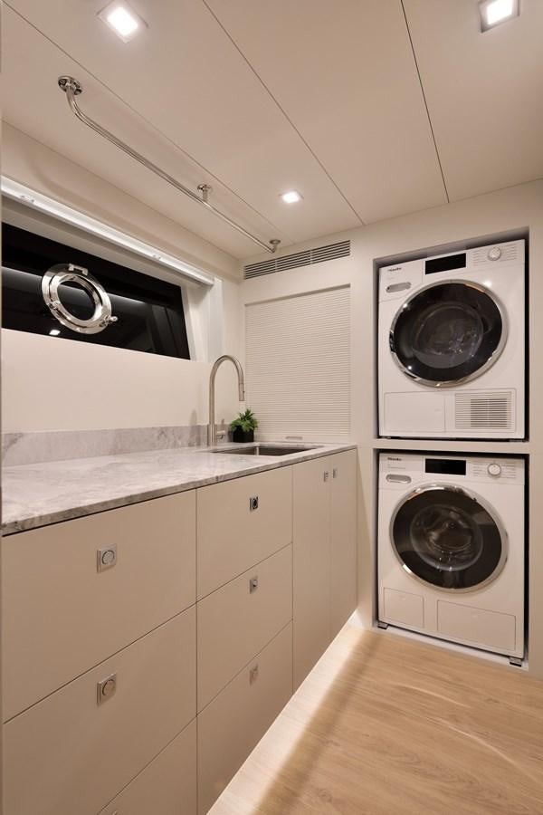 a kitchen with a washing machine and a sink aboard FD75  709 Yacht for Sale