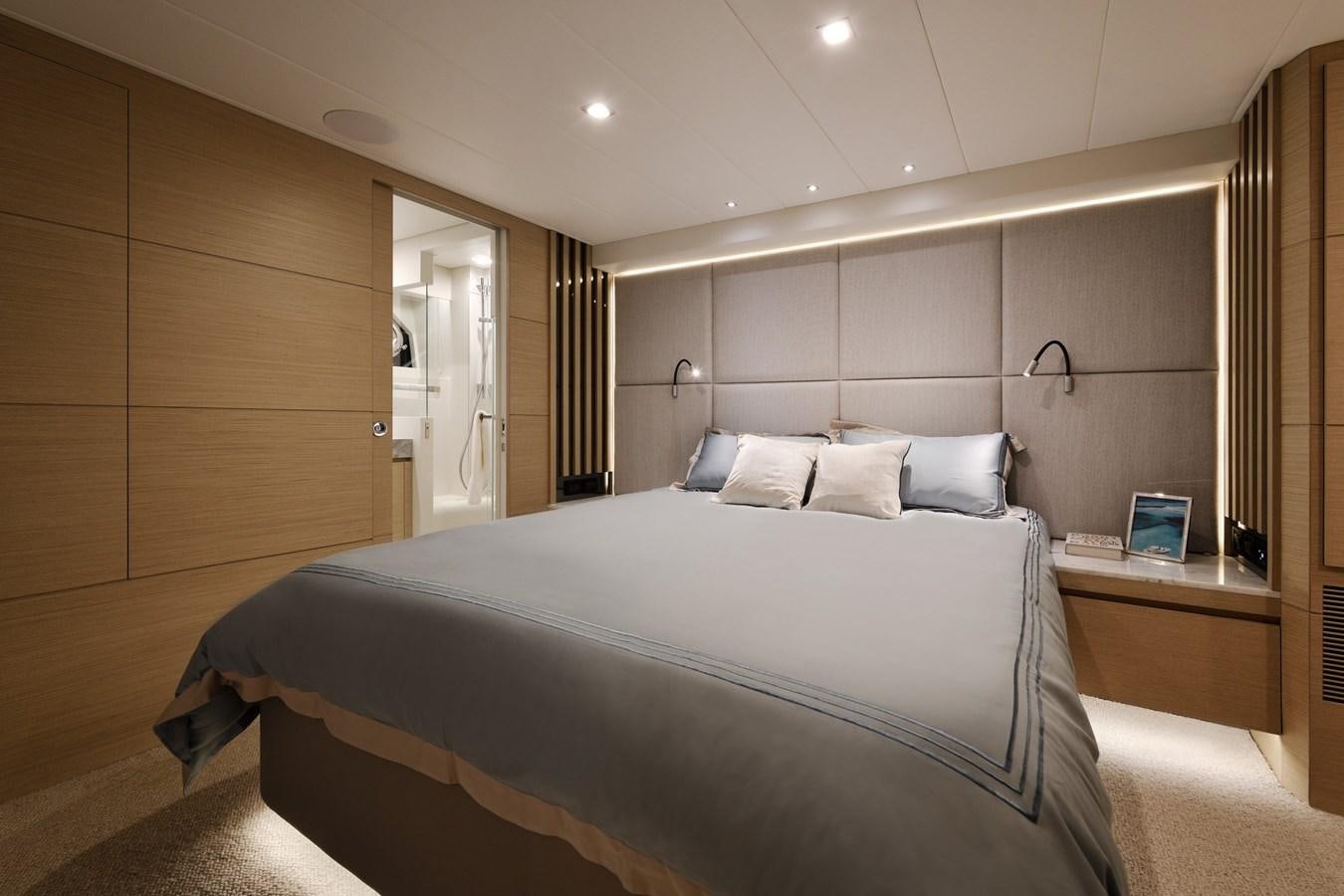 a bedroom with a bed and a mirror aboard FD75  709 Yacht for Sale