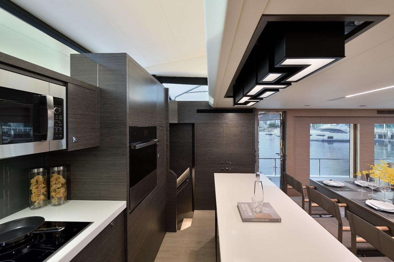 a kitchen with a table and chairs aboard FD75  709 Yacht for Sale