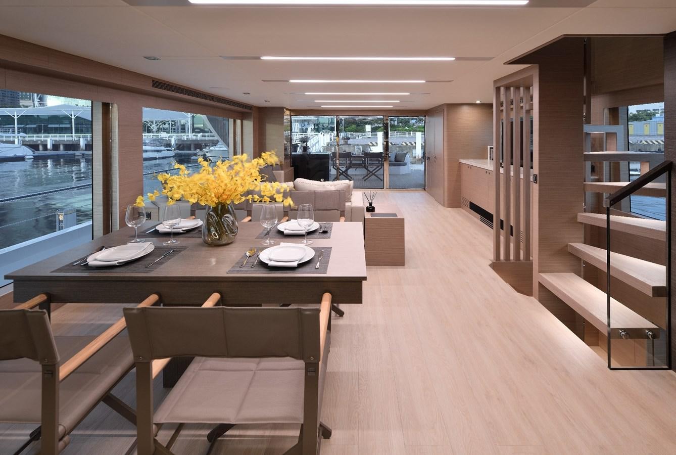 a large room with a table and chairs aboard FD75  709 Yacht for Sale