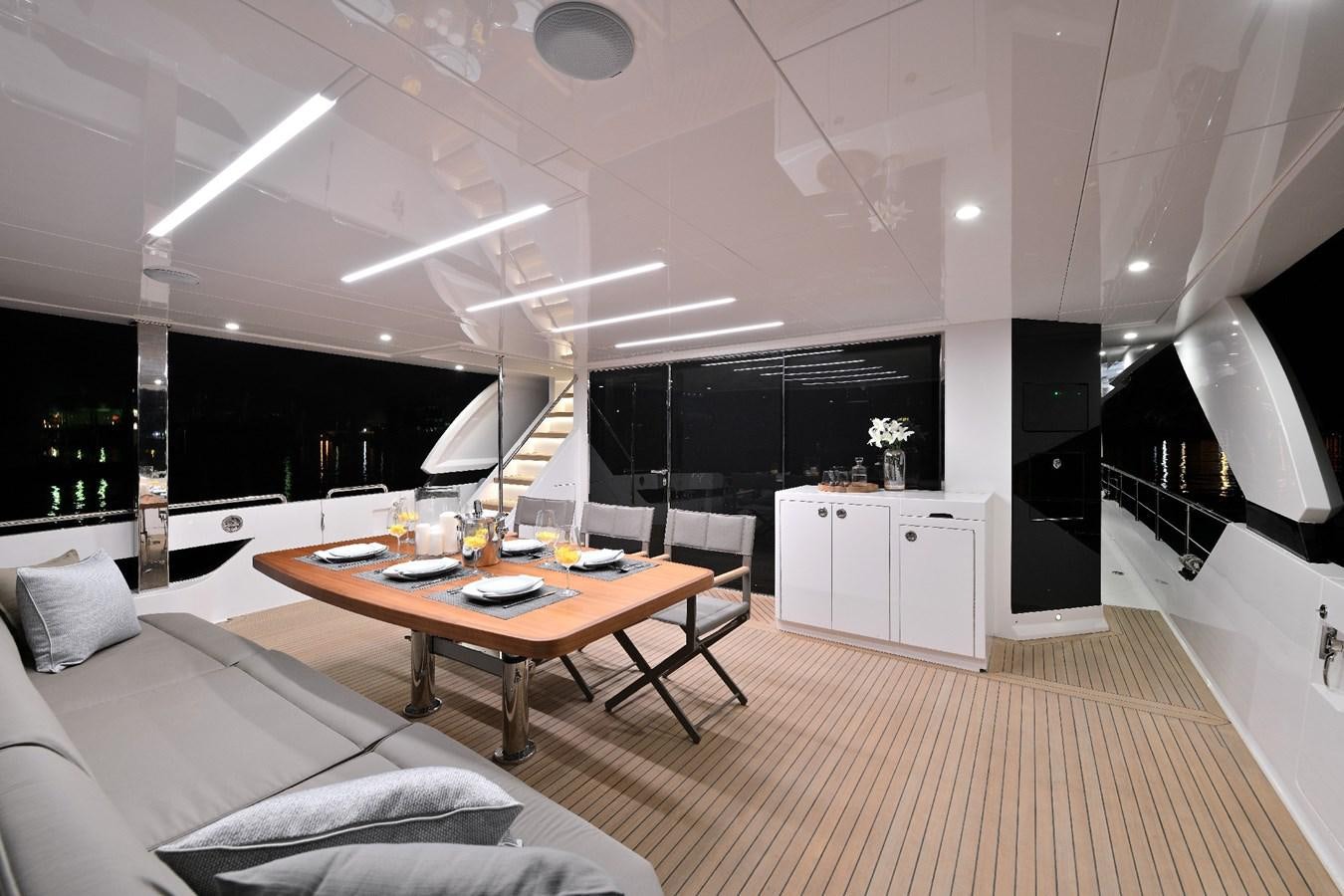 a room with a table and a couch aboard FD75  709 Yacht for Sale