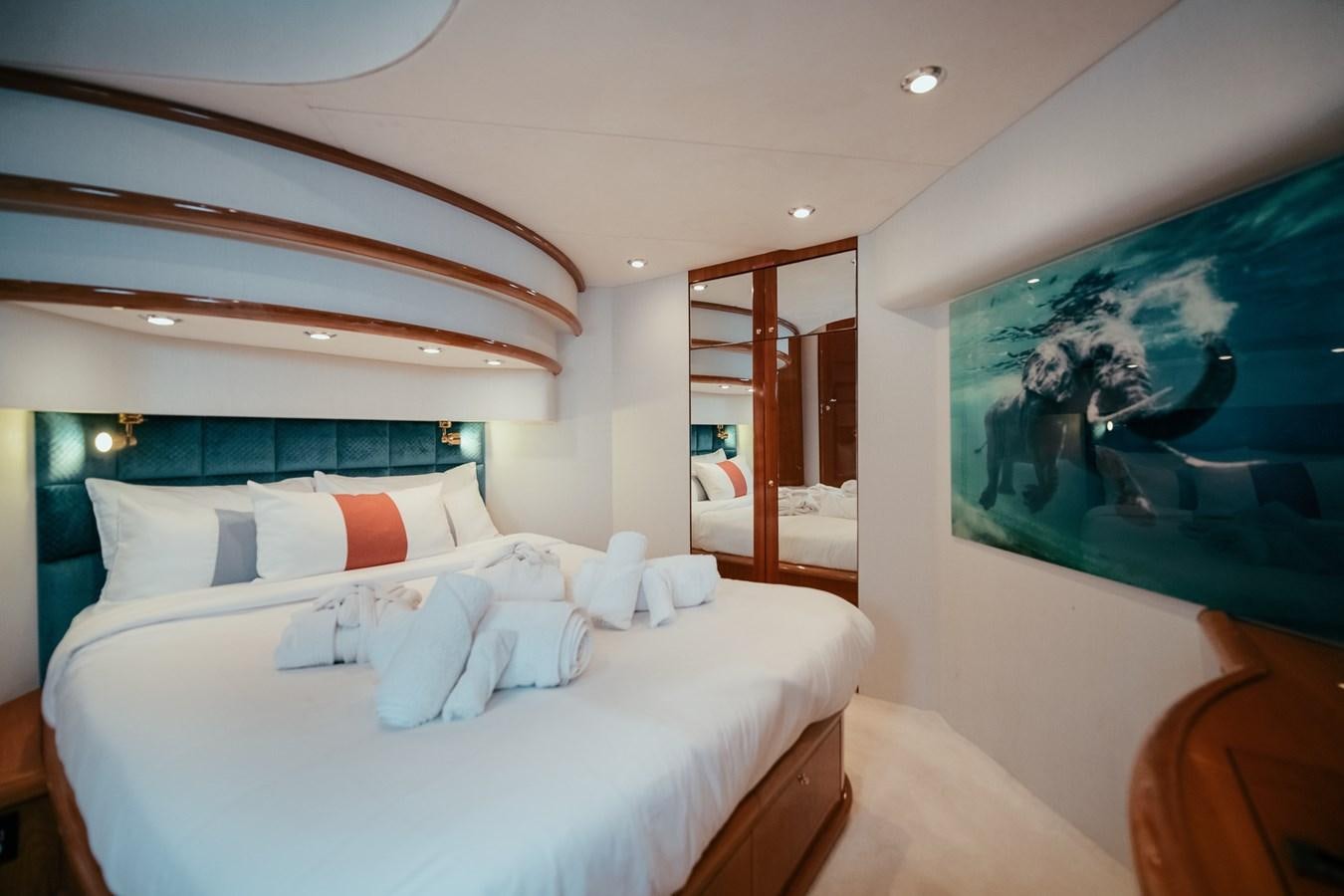 a bedroom with a large bed aboard HOURI Yacht for Sale