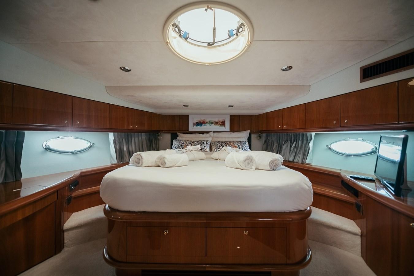 a room with a bed and a desk aboard HOURI Yacht for Sale