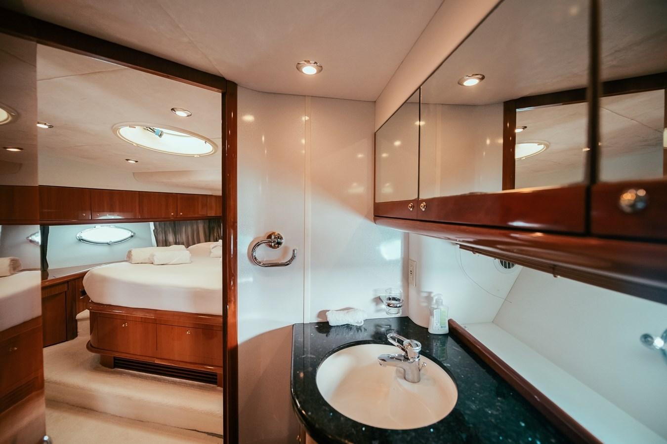 a bathroom with a sink and a bed aboard HOURI Yacht for Sale